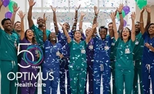 Optimus Health Care staff in scrubs celebrate 50 years with confetti and balloons