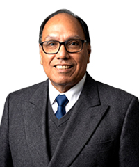 Dr. Jose Orellana, Optimus Health Care physician, wearing a dark suit and blue tie